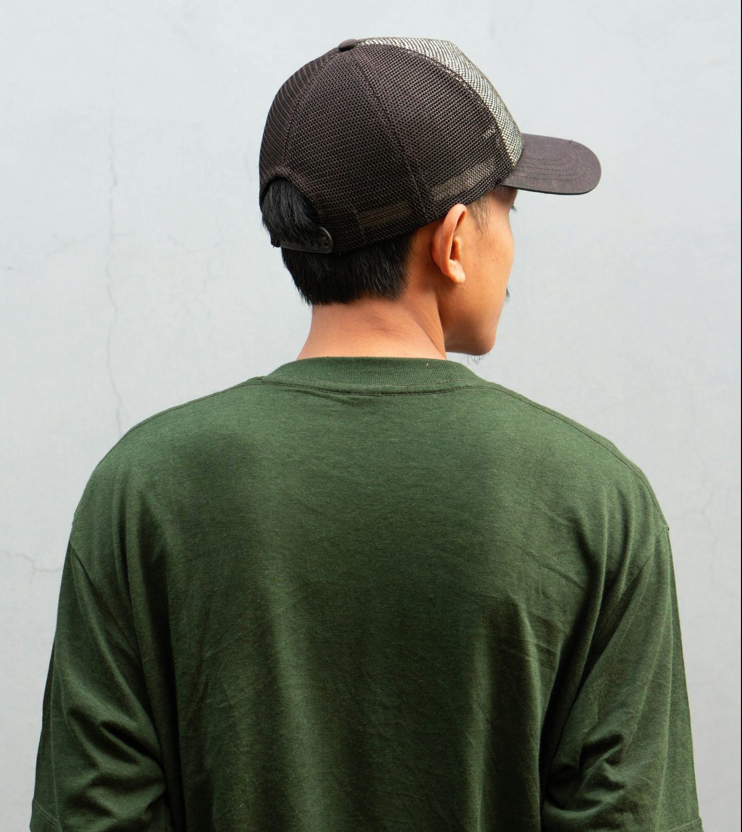 Man with hands folded at the back